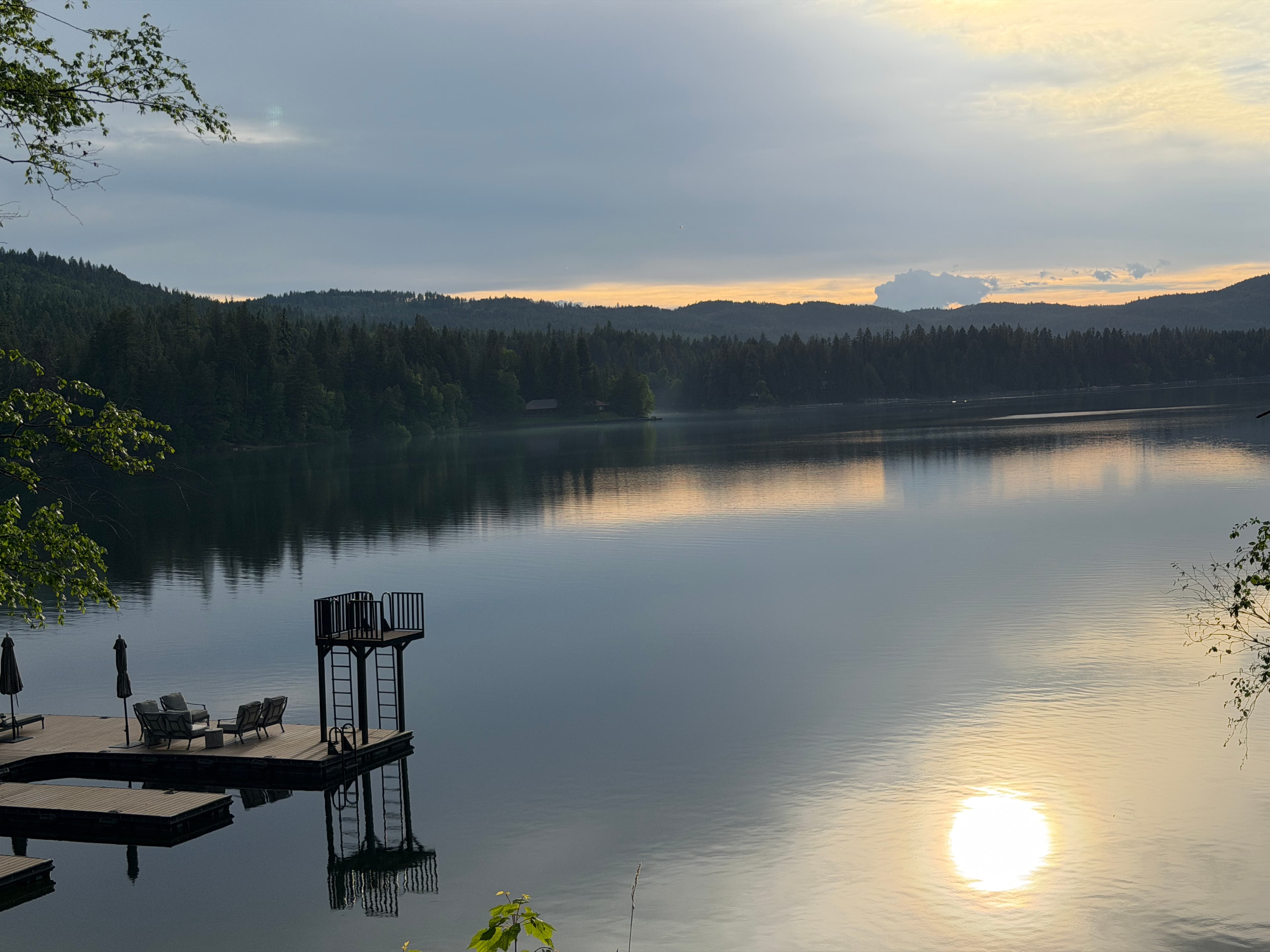 Swan Hollow - Montana waterfront with mountains and forest at sunset